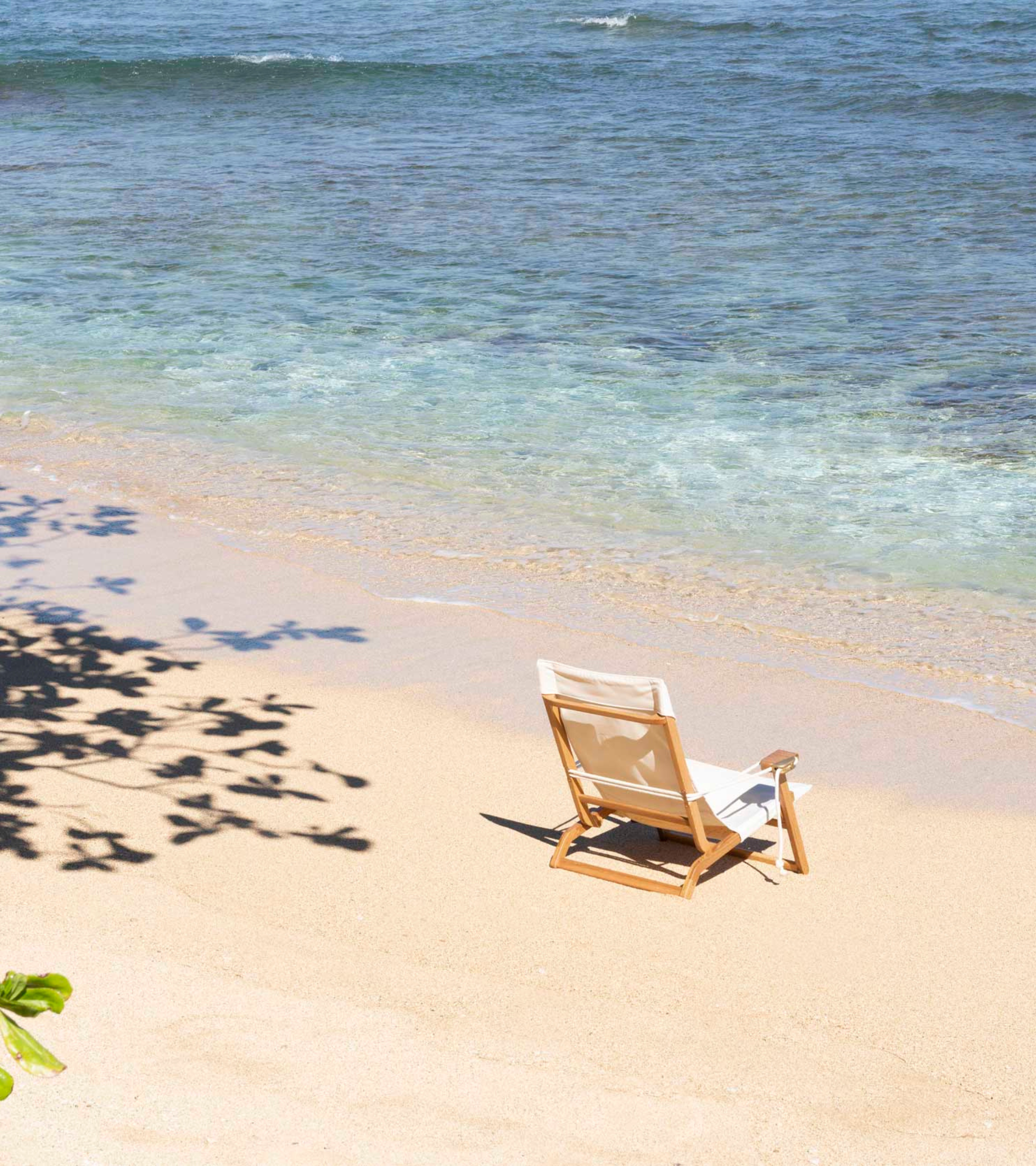 The Shorebird Beach Chair on the beach in Hawaii next to the ocean